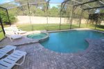 huge screen lanai with pool and lots of dining and lounge chairs